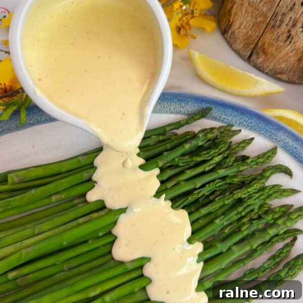 11 Flavorful Ways to Season Vegetables for Every Meal 11 hollandaise sauce being poured on asparagus