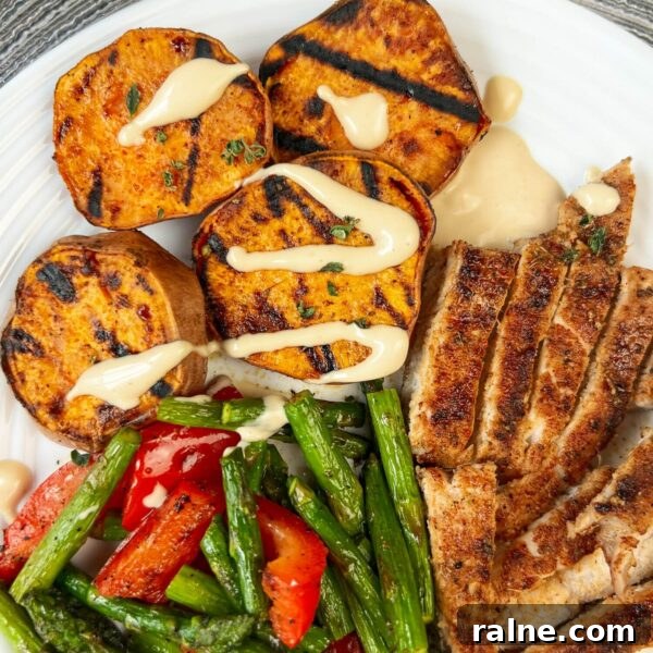 11 Flavorful Ways to Season Vegetables for Every Meal 10 bbq dinner with sliced pork chop asparagus and sweet potatoes with sauce