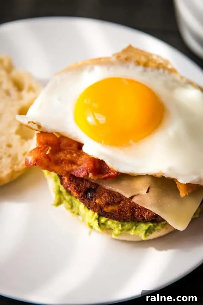 Black Bean Breakfast Burger with Avocado and Chipotle Mayo 7 sunny side up egg on a sandwich