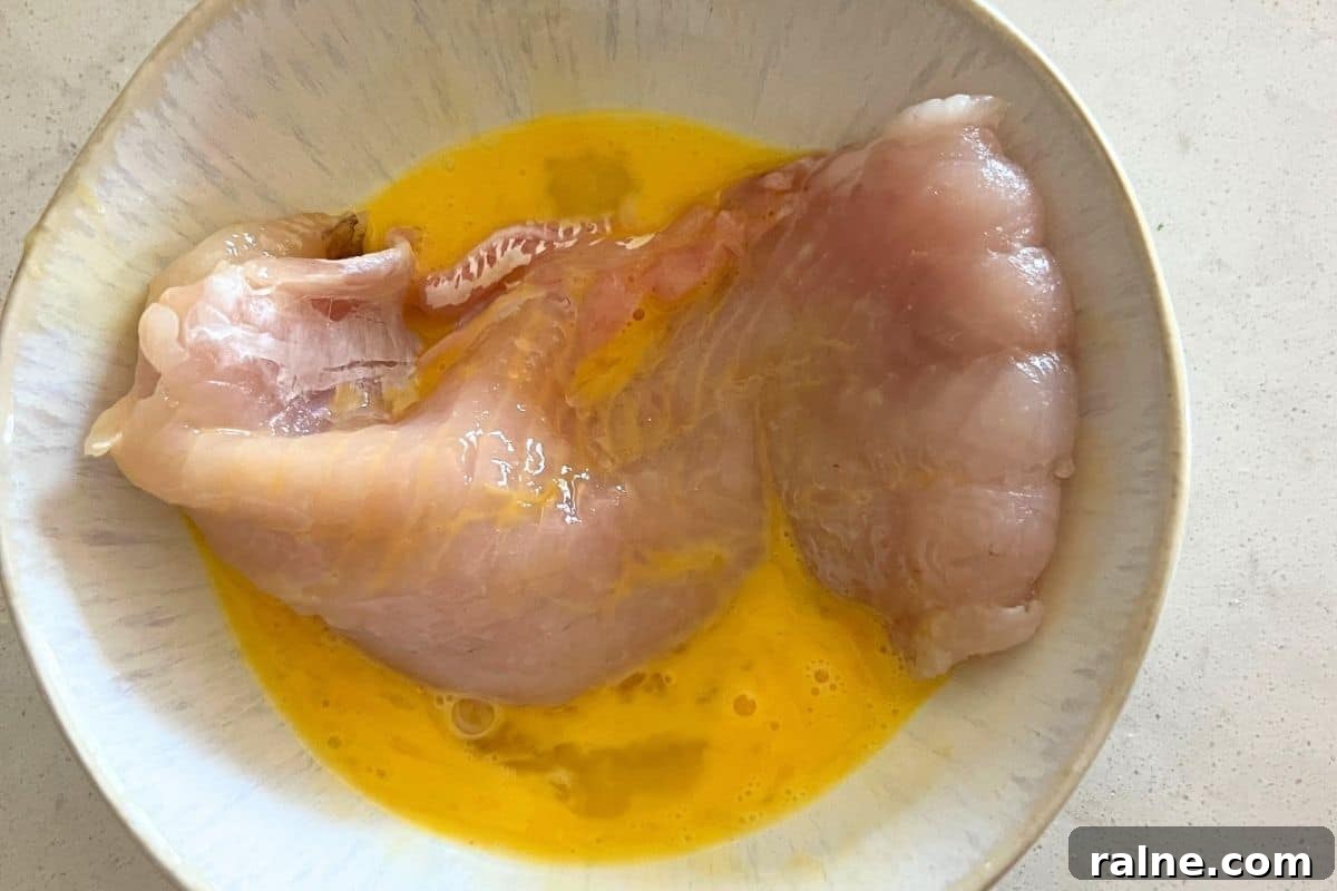 Crispy Air-Fryer Walleye Recipe for Golden, Flaky Fish 3 Walleye dipped in egg wash mixture.