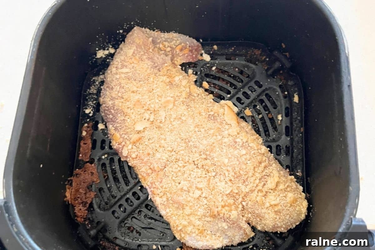 Crispy Air-Fryer Walleye Recipe for Golden, Flaky Fish 5 Walleye in air fryer basket.