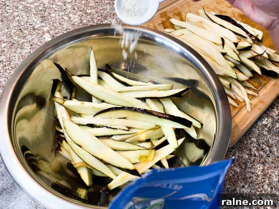 Summer Eggplant Jerky Recipe: Crispy Savory Plant-Based Snack 4 Pouring salt into water bowl filled with eggplant slices