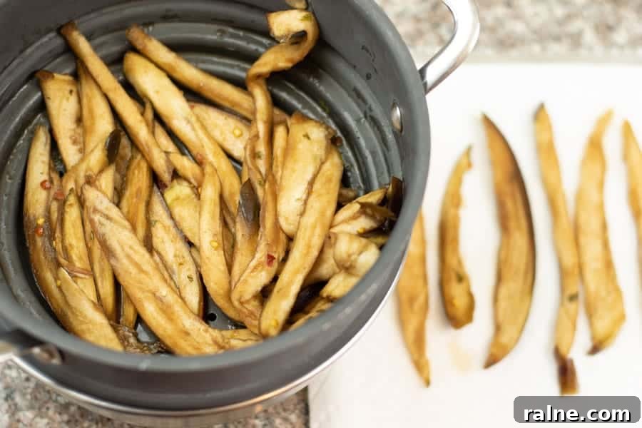 Summer Eggplant Jerky Recipe: Crispy Savory Plant-Based Snack 9 Eggplant jerky in colander and on paper towel