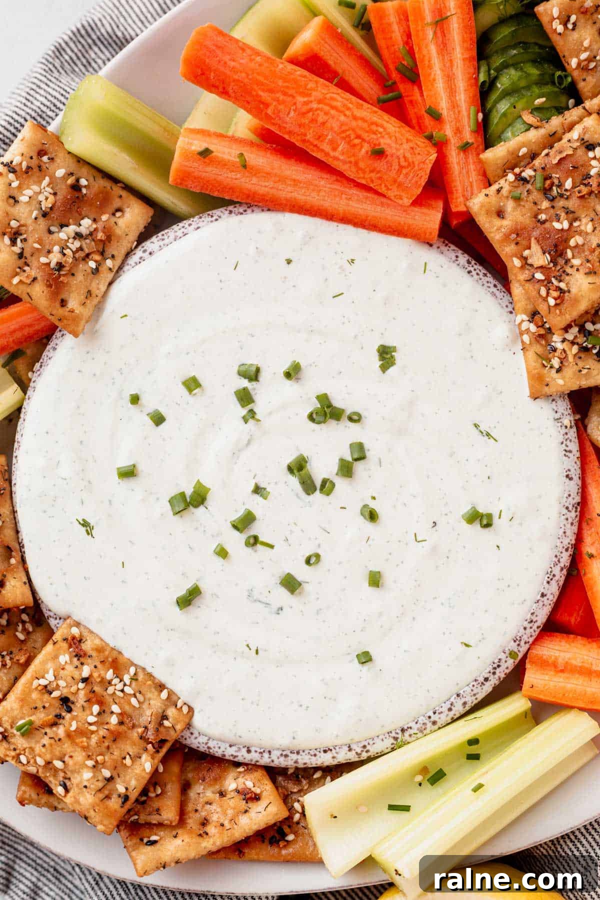 Creamy Cottage Cheese Dip Recipe for Fresh Veggies and Chips 3 a bowl of cottage cheese dip surround by carrots and seasoned crackers