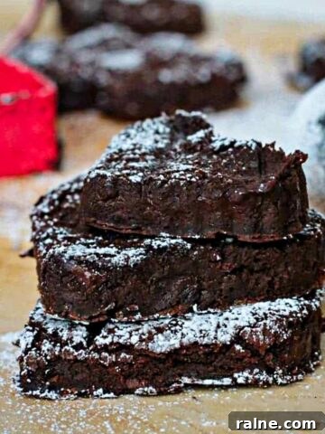 Stack of three sugared black bean brownies.