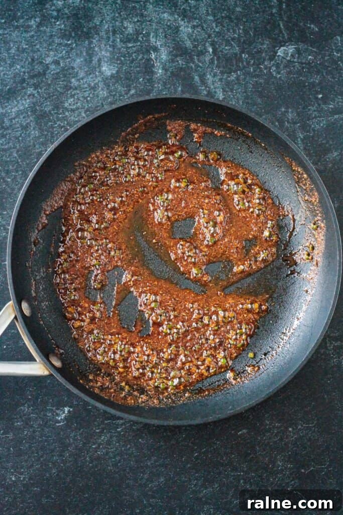 Zesty Spiced Black Beans Recipe for Bold Flavor 4 Spices simmering in oil in a skillet.