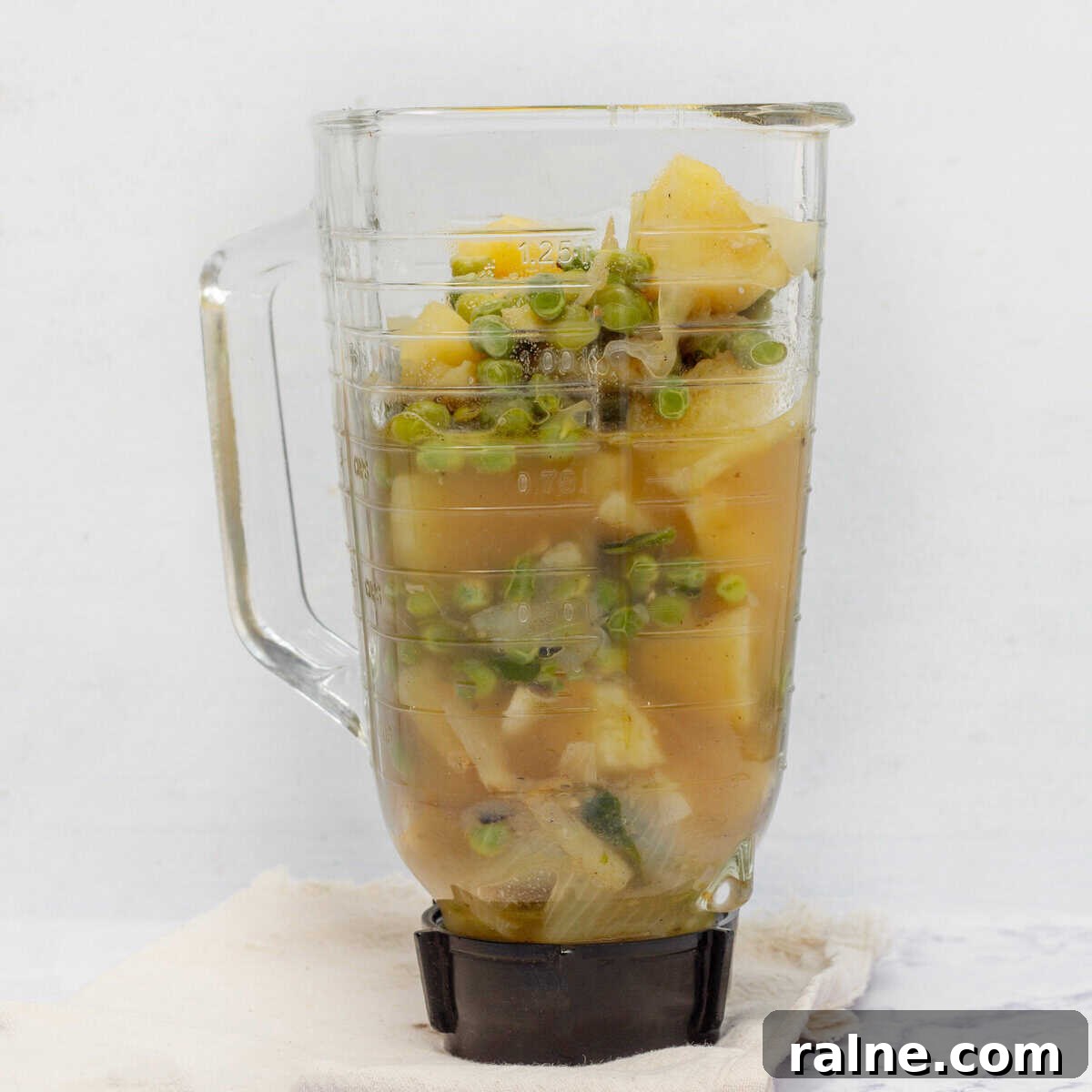 Cooked soup ingredients in a blender.