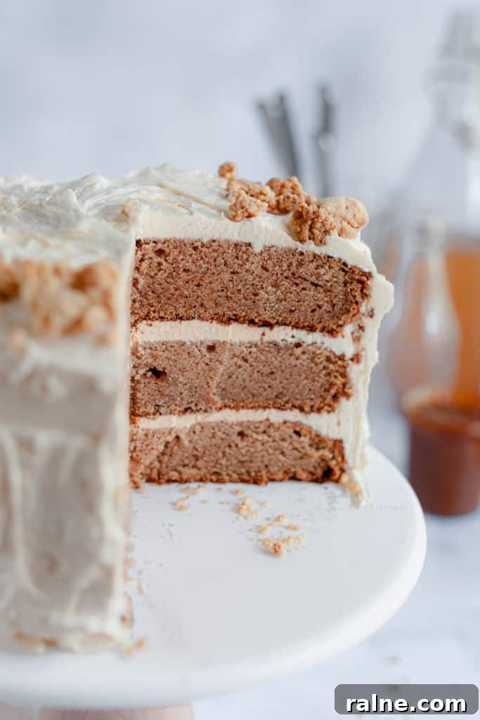 Apple Cider Layer Cake with Pie-Crumb Frosting and Salted Caramel Filling 5 Apple cider cake close up with a large slice taken out