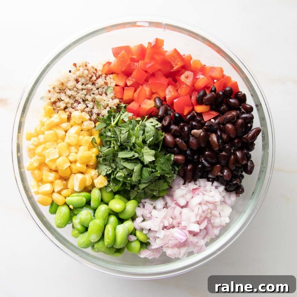 Southwest Quinoa Salad with Black Beans, Corn & Lime Dressing 7 Quinoa, beans, edamame, corn, bell peppers and onions in a bowl.