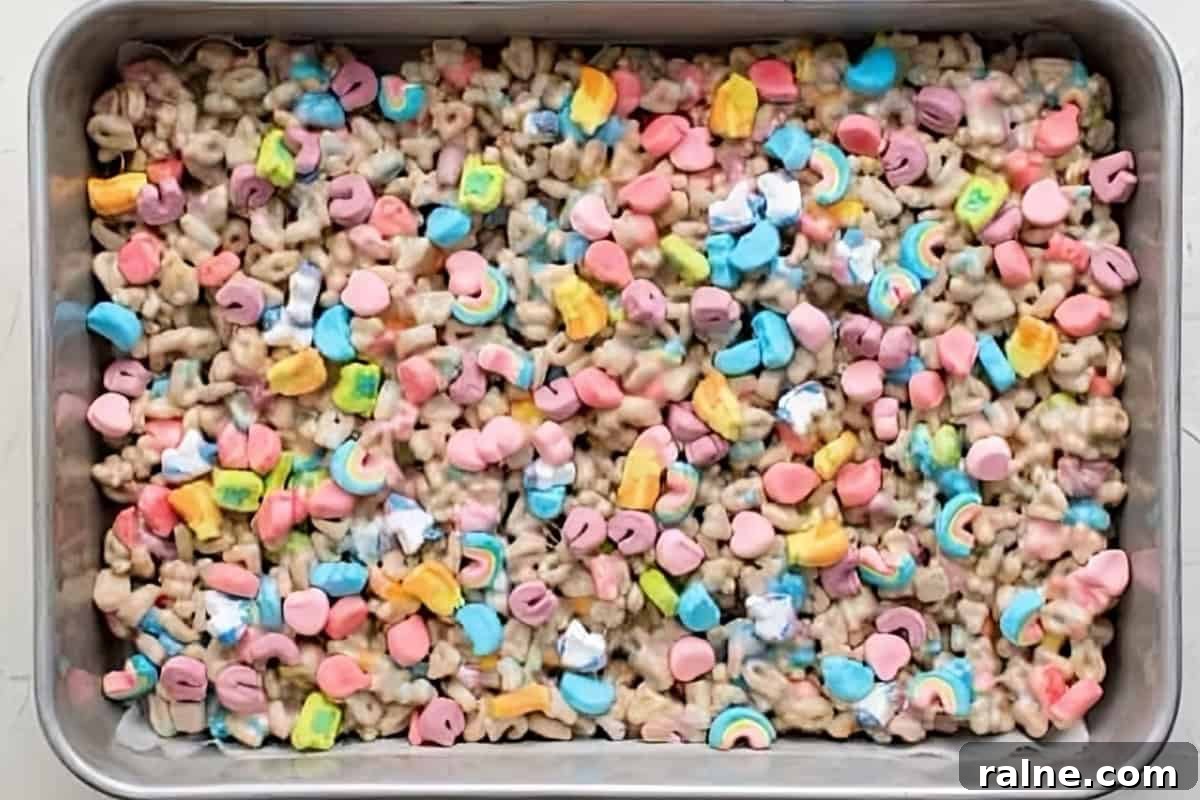 Lucky Charms mixture spread into a pan.