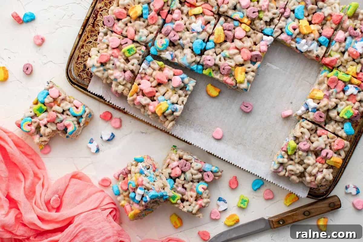 Sliced Lucky Charms rice krispies treats in a pan.