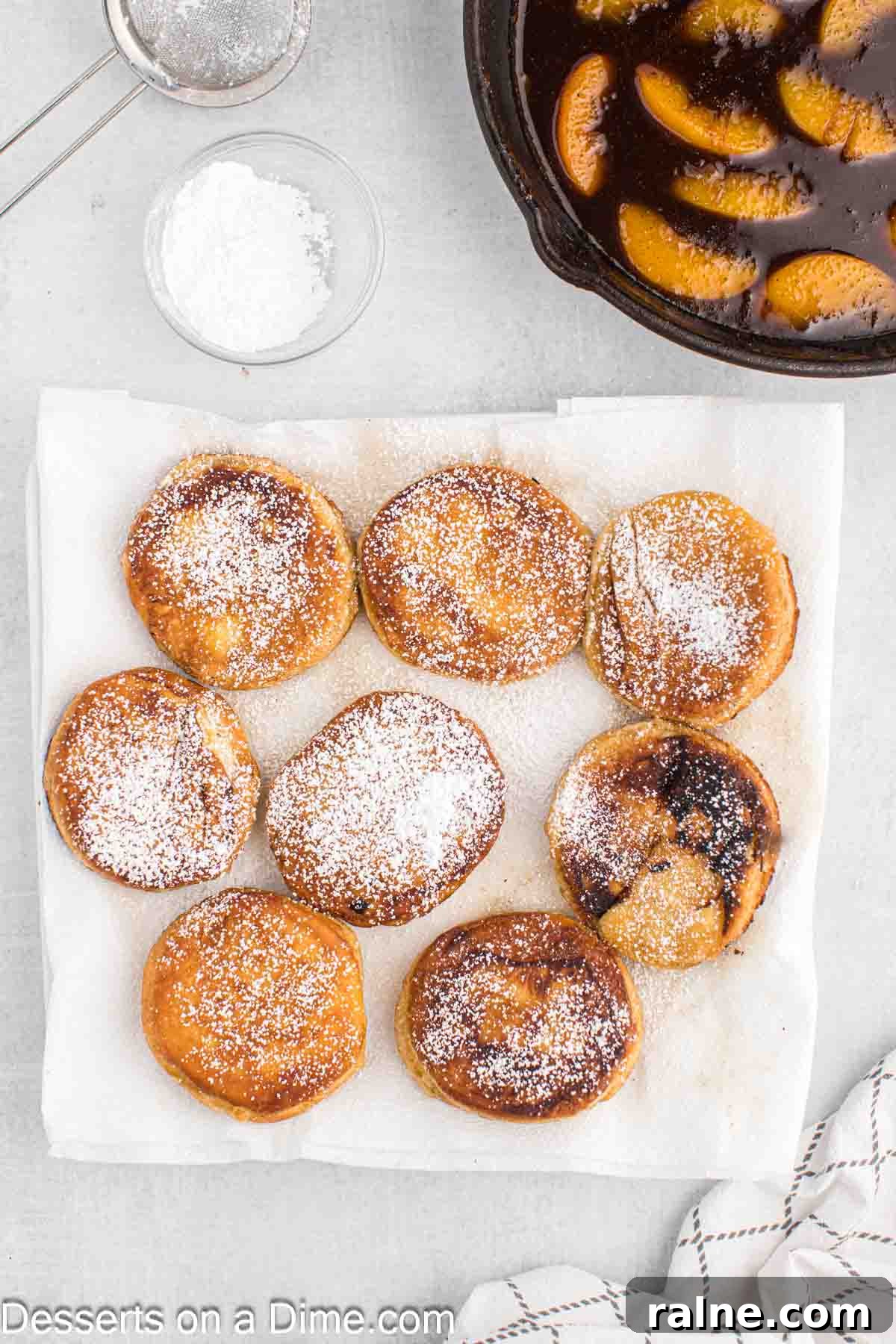 Crispy Fried Peach Cobbler: Southern Dessert Recipe 7 Powdered sugar sprinkled on the biscuits.