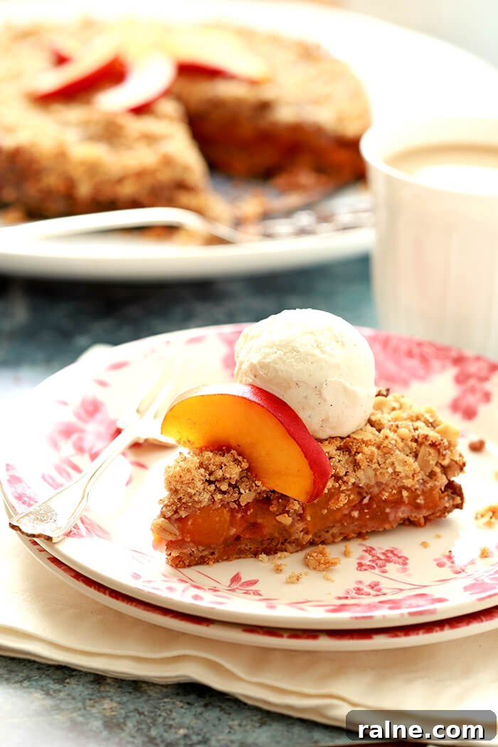 Peach and Pecan Double-Crust Crisp Recipe 2 Slice of Fresh Double Crusted Peach and Pecan Crisp on a White Plate with Pink Decorations