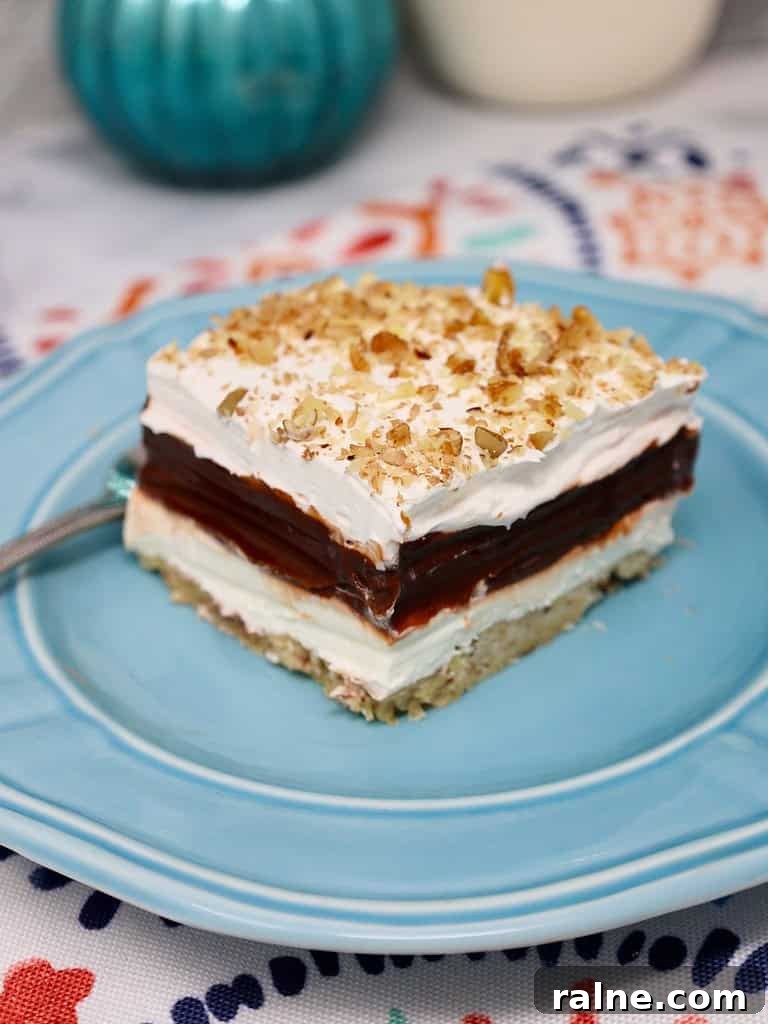 four layer delight topped with chopped pecans for a crunchy texture