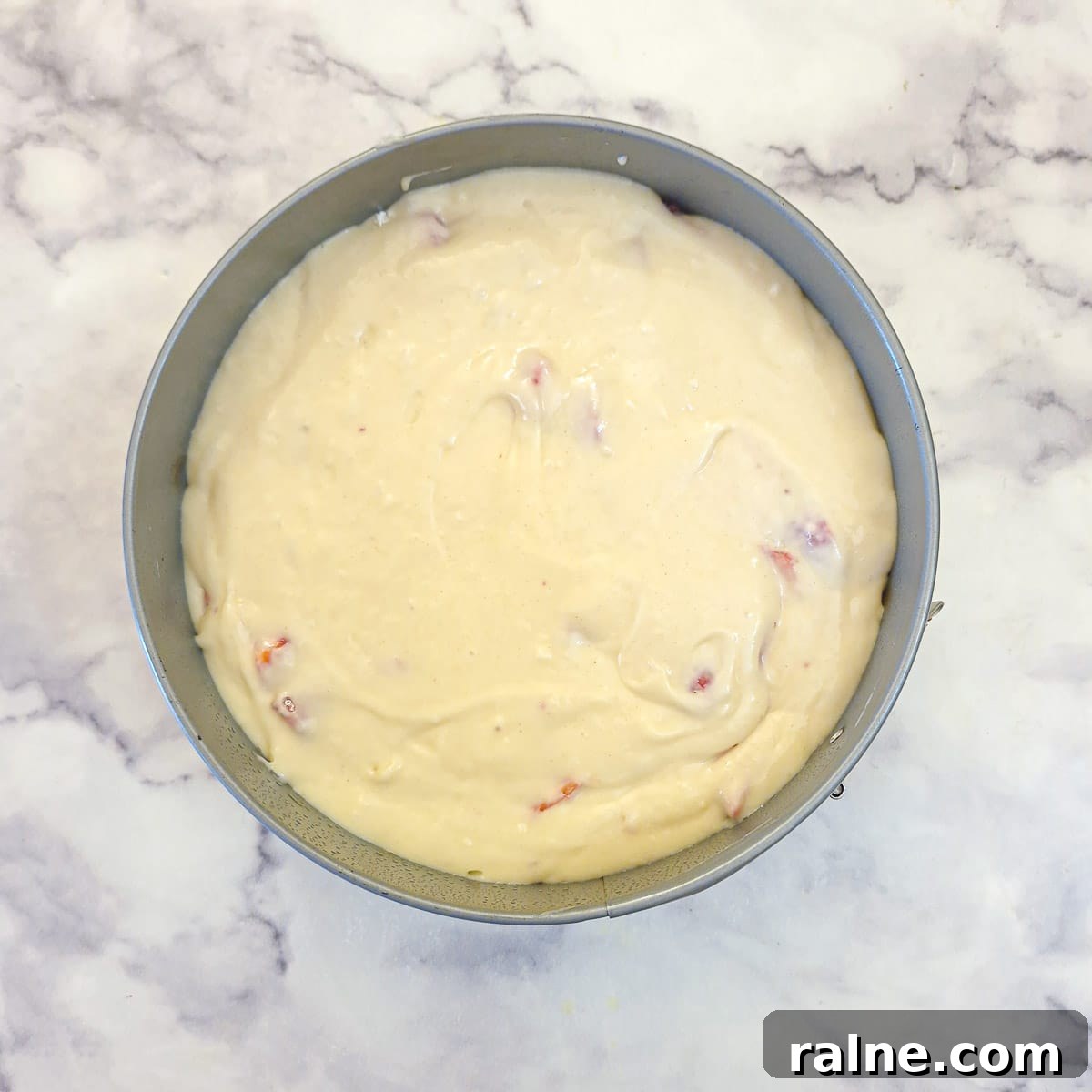 Light Mascarpone Strawberry Cake Without Butter — Moist Summer Dessert 11 Raw strawberry cake batter poured into a round cake pan.