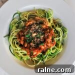 A top down view of a bowl of vegan puttanesca zoodles.