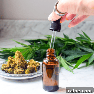 A hand with a cannabis tincture bottle.