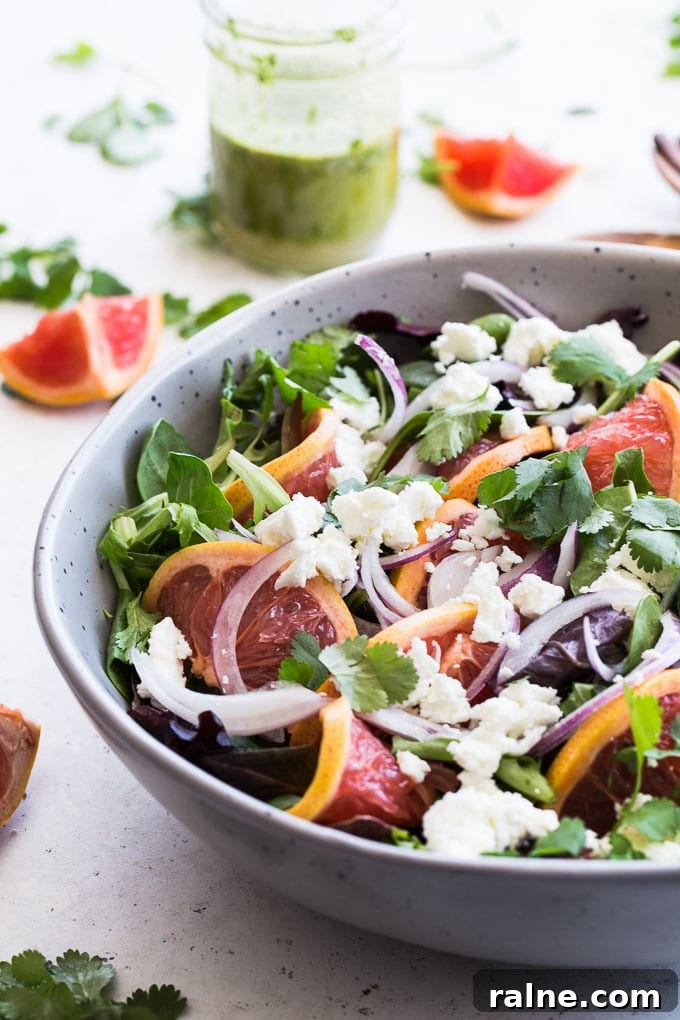 Up-close side view of Grapefruit Salad with Cilantro and Goat Cheese in a grey bowl.