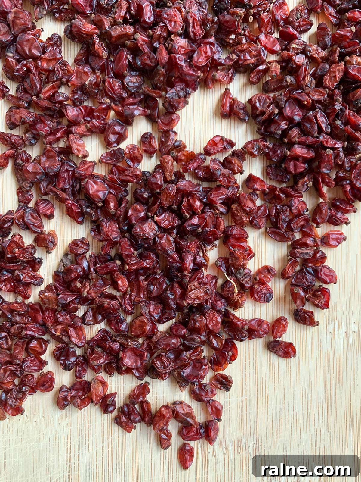 Barberries (Zereshk): A Culinary Guide to Persia’s Tangy Jewel 5 Barberries on a bamboo cutting board.