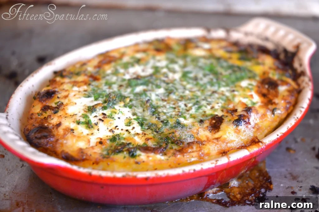 HerbedEggs Baked Eggs - In Red Dish with Parmesan and Herbs