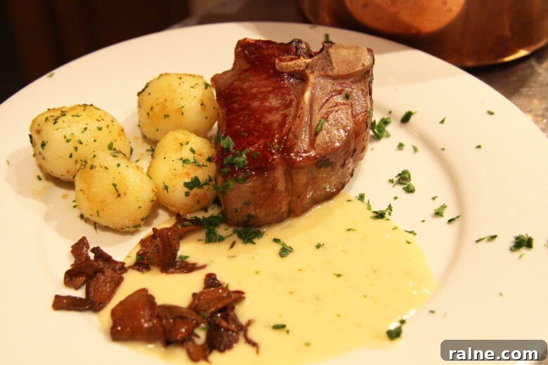 Pan-Seared Lamb Chops with Garlic Cream Sauce and Porcini Mushrooms 3 Pan fired lamb chops with garlic cream and porcini mushrooms served on a plate alongside small potatoes