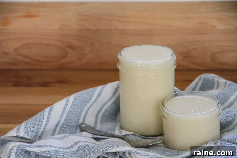 How to Make Smooth Creamed Honey at Home 7 Two jars of creamed honey sitting on a blue and white tea towel