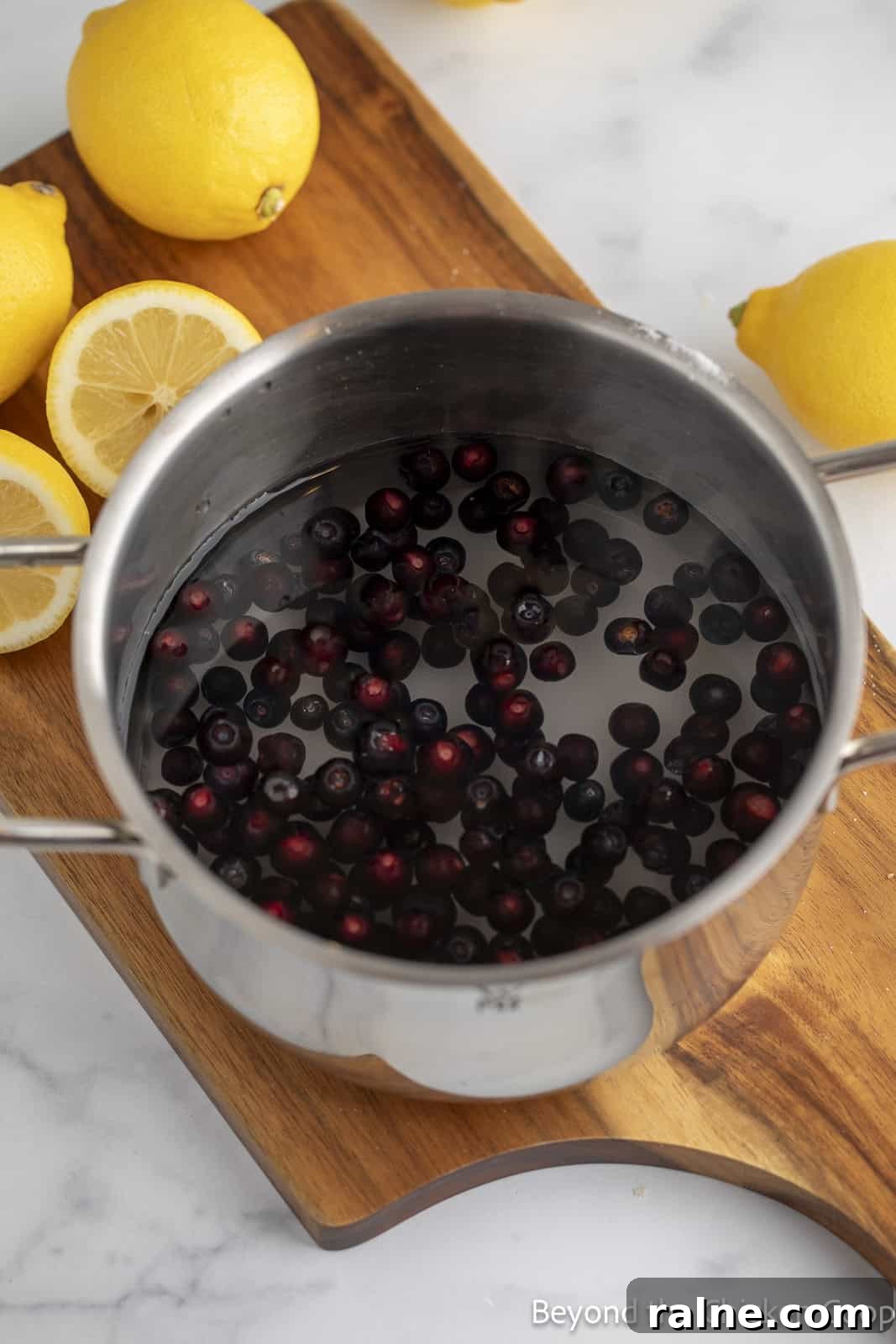 Huckleberry Lemonade Recipe: Refreshing Summer Drink with Fresh Berries 5 Huckleberries in a pot with water and sugar.