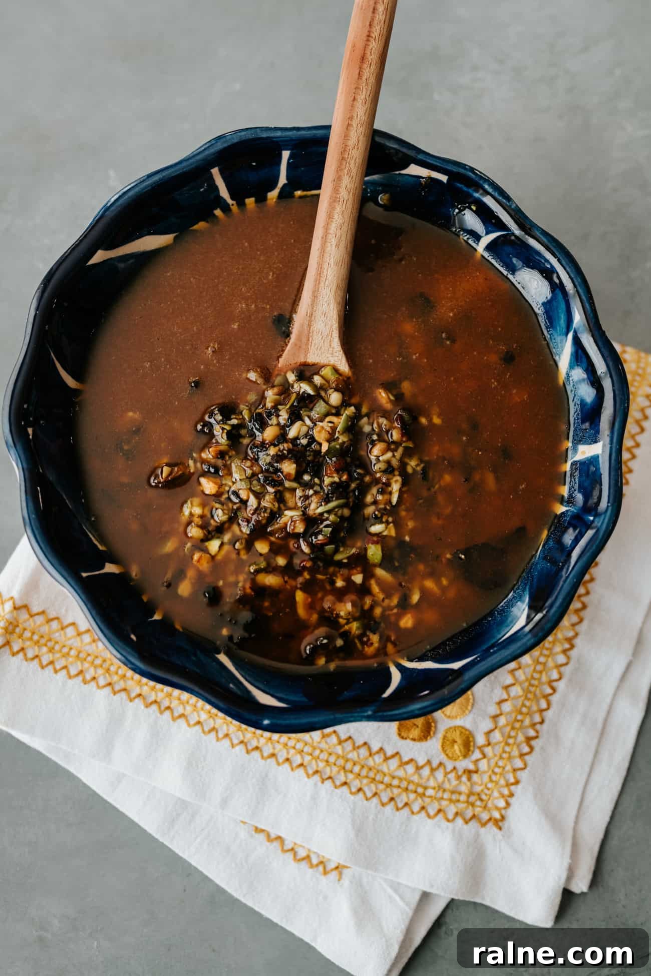salsa macha in a blue bowl with a wooden spoon.