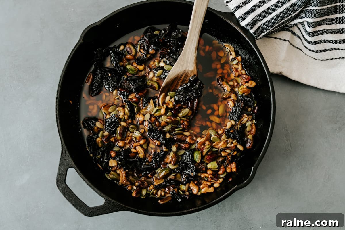 overhead shot of cast iron filled with salsa macha on a gray surface.