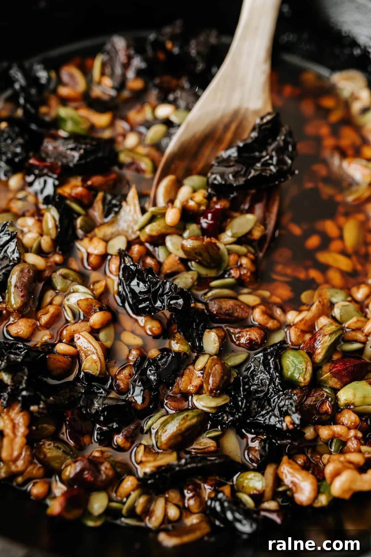 close up view of nuts and chiles in a cast iron skillet to make salsa macha.