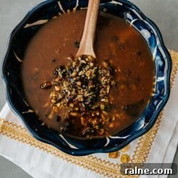 salsa macha in a blue bowl with a wooden spoon.
