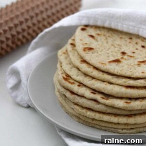 Soft Swedish Tunnbröd Recipe: How to Make Traditional Flatbreads 15 Soft Swedish Flatbreads on a plate next to a towel and a spiky rolling pin.