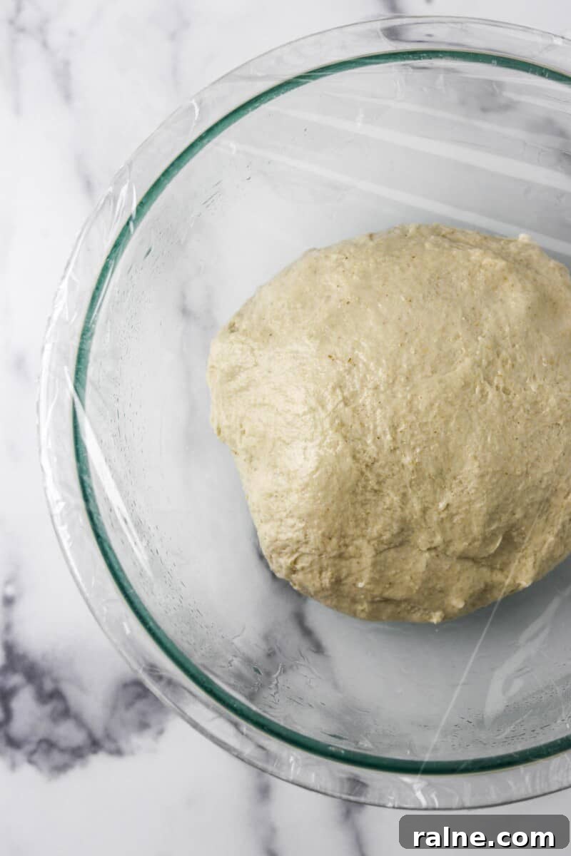 Soft Swedish Tunnbröd Recipe: How to Make Traditional Flatbreads 6 Flatbread dough in a glass bowl covered in plastic wrap.
