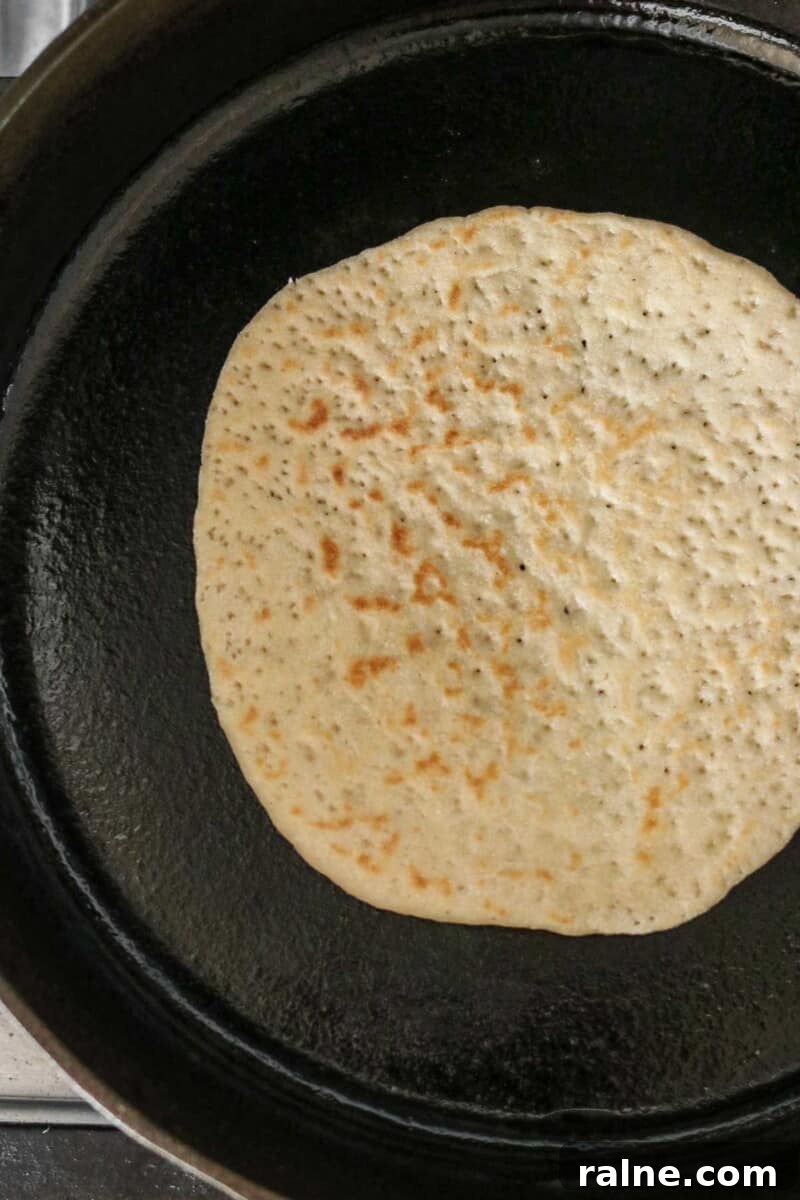 Soft Swedish Tunnbröd Recipe: How to Make Traditional Flatbreads 10 Flatbread cooking in a cast iron skillet.