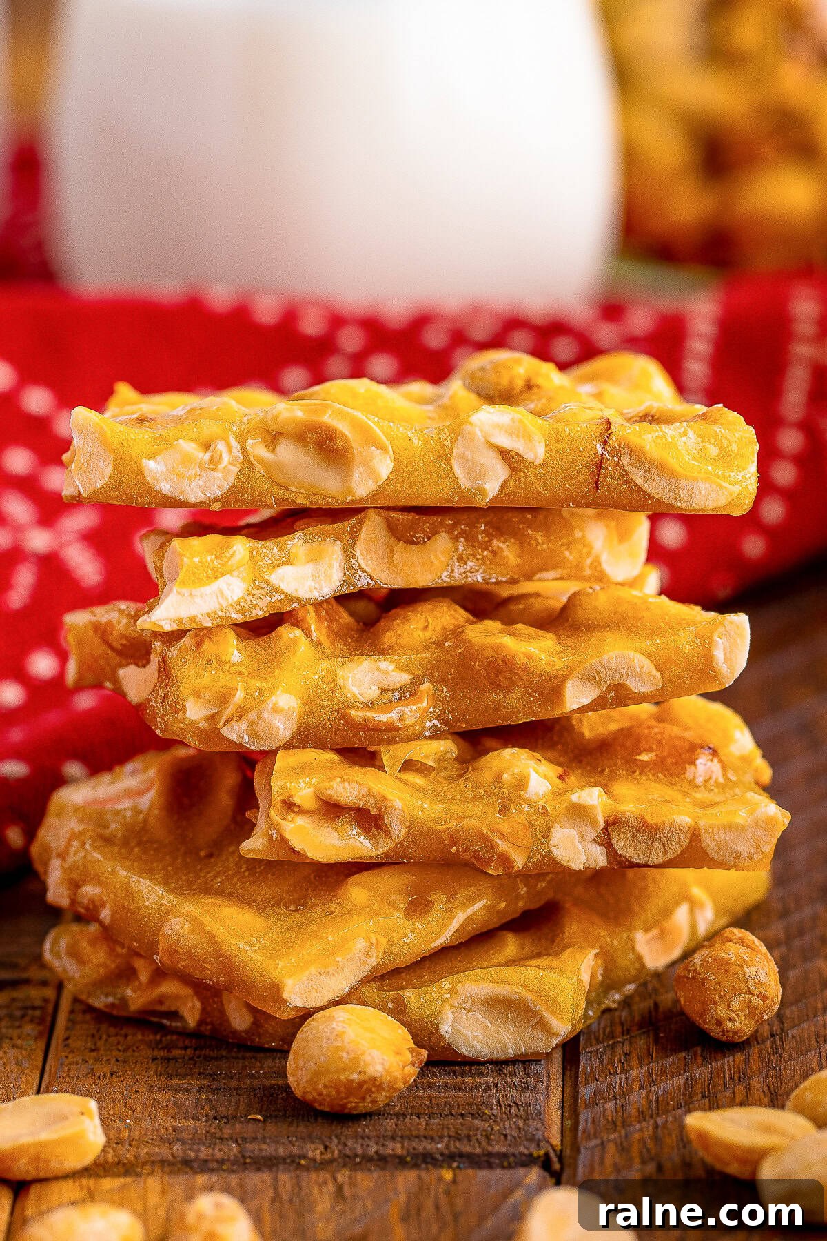 a stack of Microwave Peanut Brittle on a wooden table top