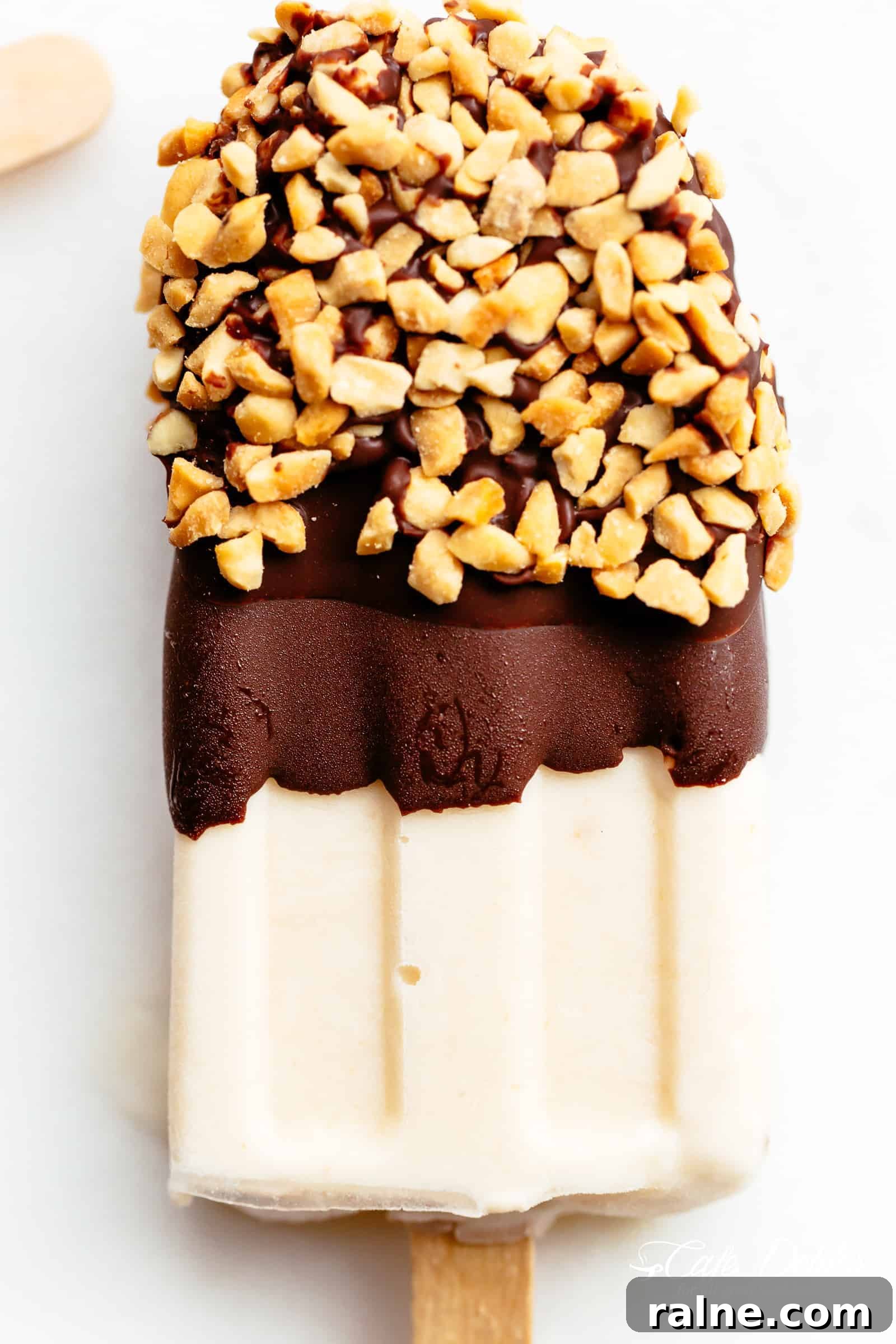 Creamy Banana Popsicle Recipe: 4-Ingredient Frozen Treat 10 Chocolate dipped Banana Popsicles garnished with crushed nuts
