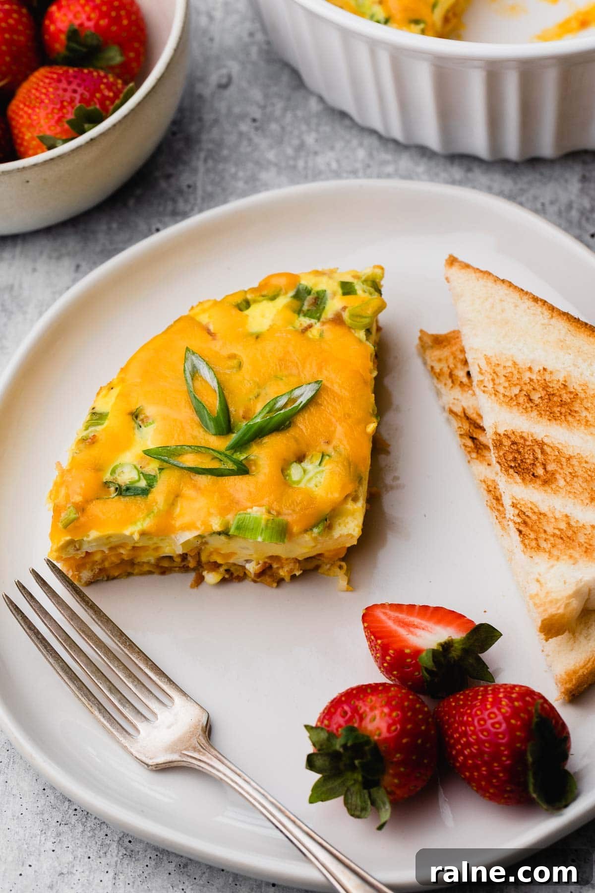 Instant Pot Egg and Sausage Breakfast Casserole 9 A plate of egg casserole, toast, and strawberries.