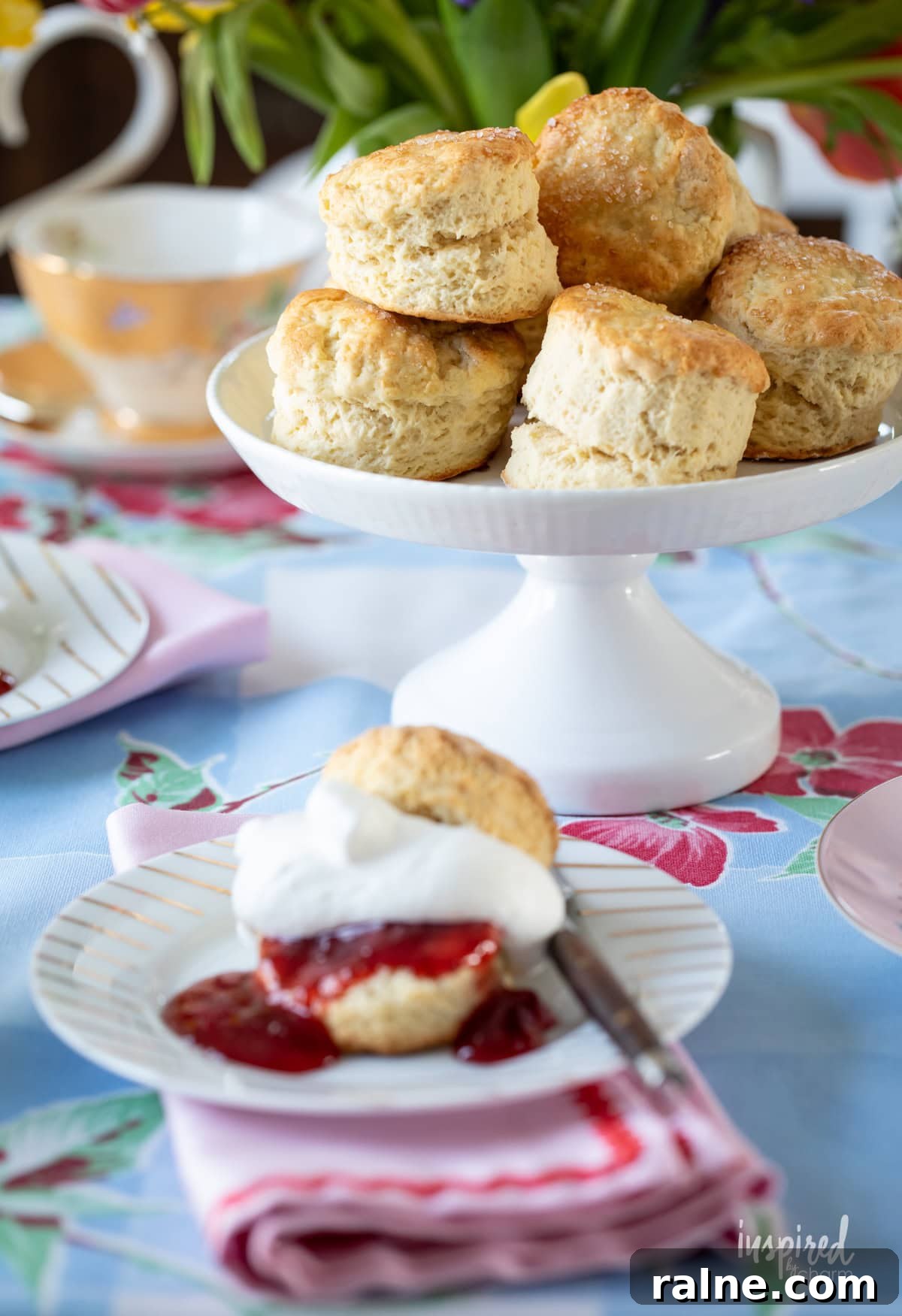 cake stand filled with homemade scones with on served on a small plate.