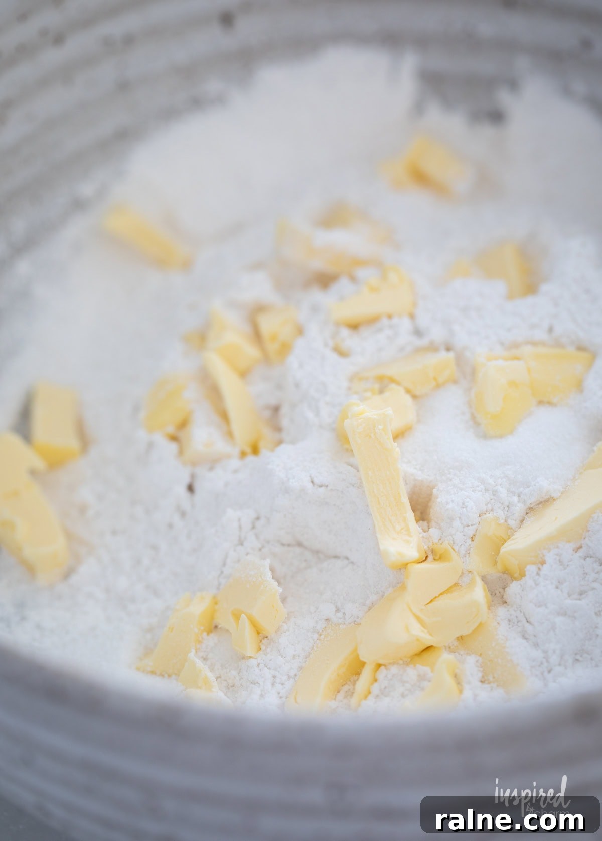 cut up butter in flour in a bowl for scones.