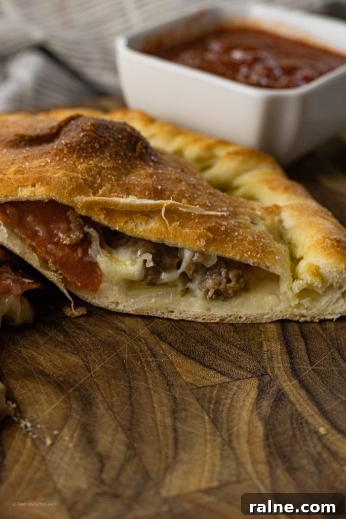 calzone sliced in half with toppings falling out