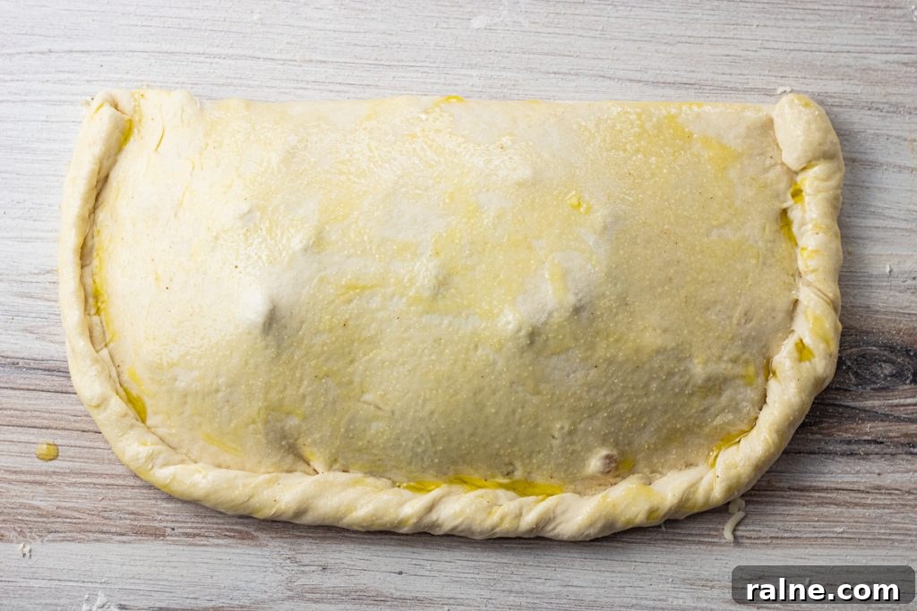 pizza dough filled and folded in half to make a calzone