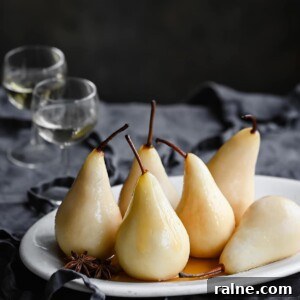 Wine-Poached Pears Recipe: Elegant Dessert with Red Wine Glaze 5 White wine poached pears on table with two glasses of wine.