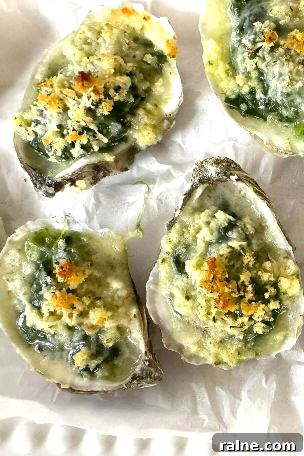 Oysters Rockefeller with Frozen Creamed Spinach: Quick Recipe 3 4 baked oysters Rockefeller style on a plate.