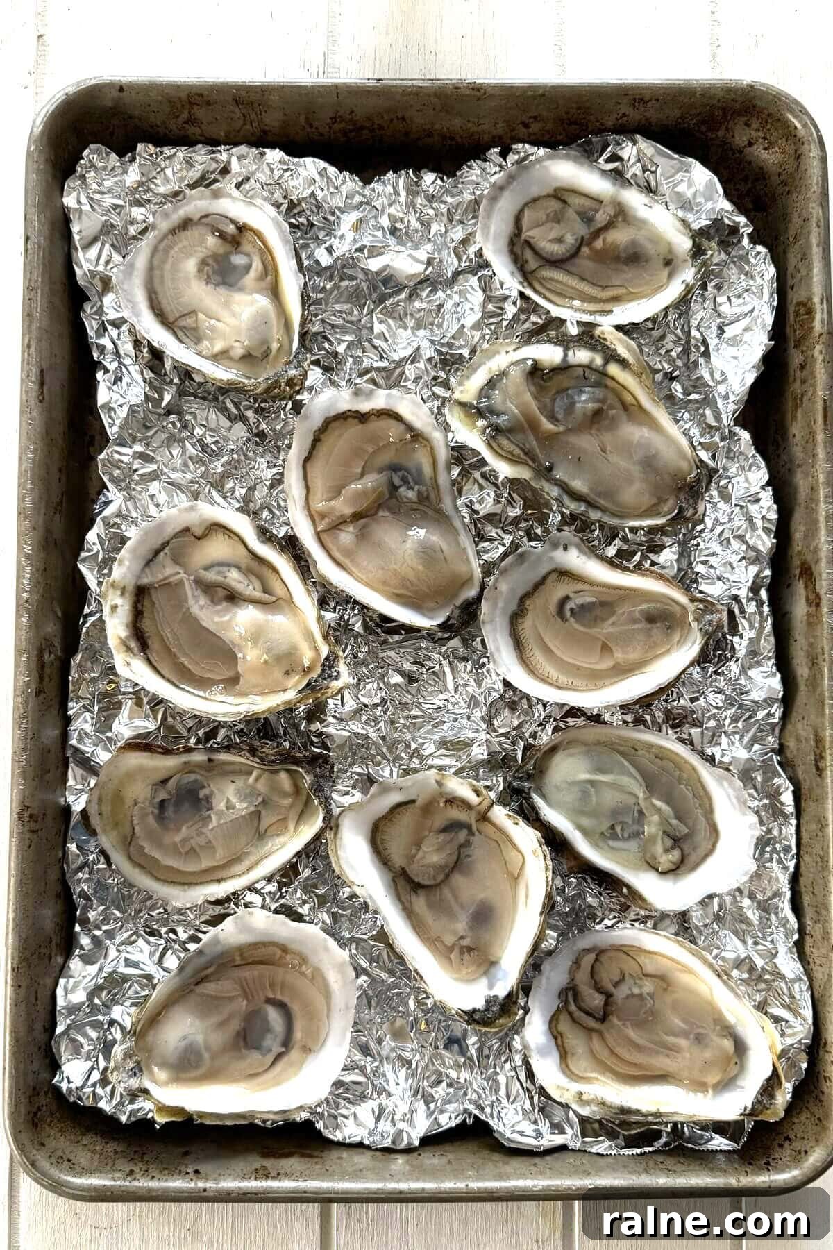 Oysters Rockefeller with Frozen Creamed Spinach: Quick Recipe 5 Shucked oysters for Rockefeller on crumpled foil on a baking sheet.