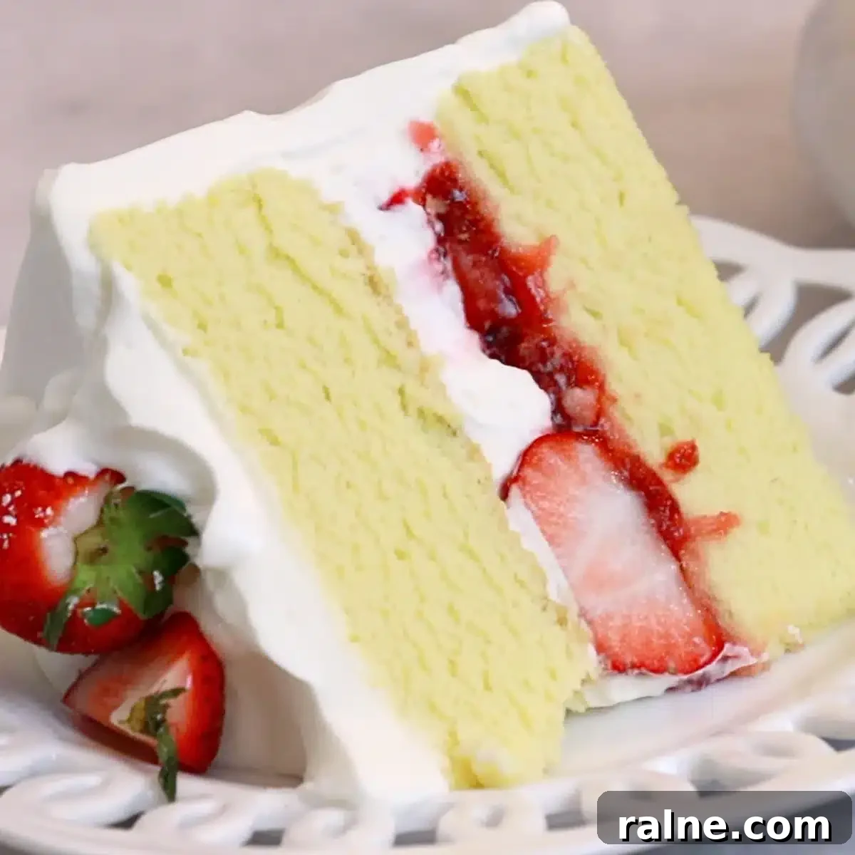 Decadent Strawberry Cream Layer Cake Recipe 2 a slice of strawberry cream cake on a white plate