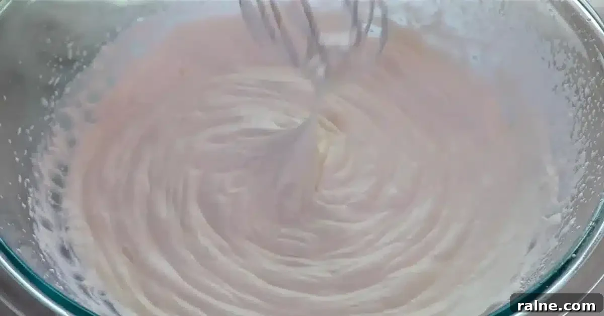 Decadent Strawberry Cream Layer Cake Recipe 16 whipped heavy cream and sugar in a bowl