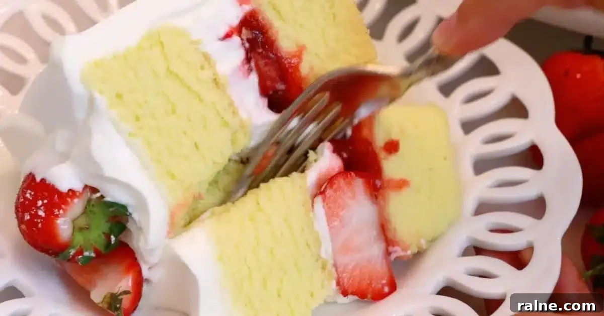 Decadent Strawberry Cream Layer Cake Recipe 27 cutting a slice of strawberry cream cake with a fork