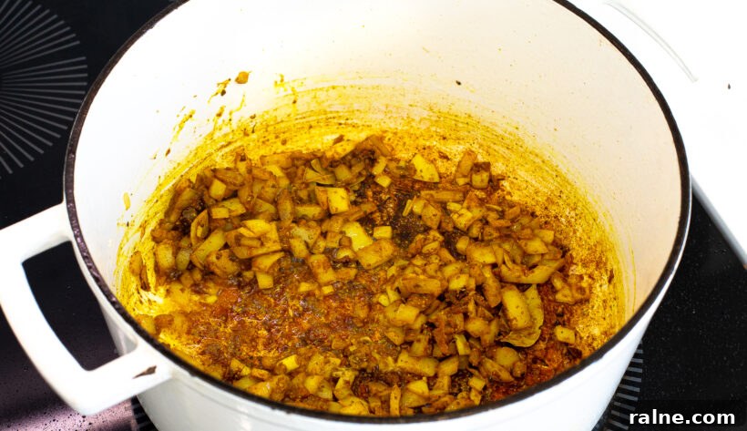 Authentic Latin-Style Chicken and Rice Recipe 6 Onions sautéing in a large stock pot.