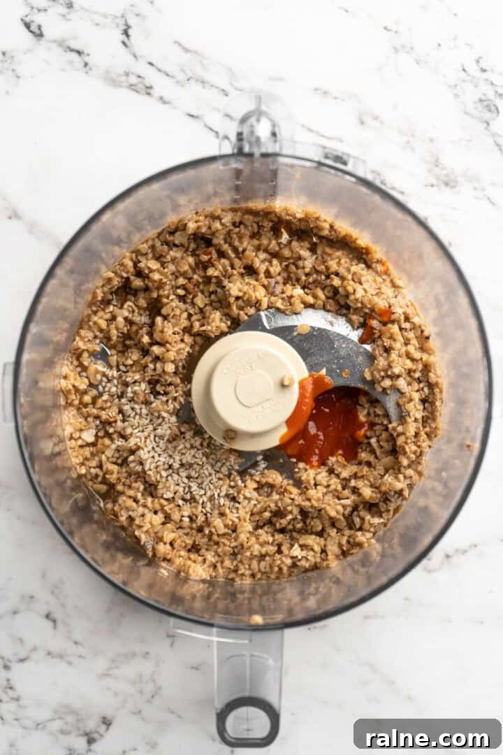 Whether you’re looking for a no-cook dinner or something light and refreshing, you’re going to love these easy Asian-inspired lettuce wraps! Overhead view of sauce ingredients added to walnut meat in food processor