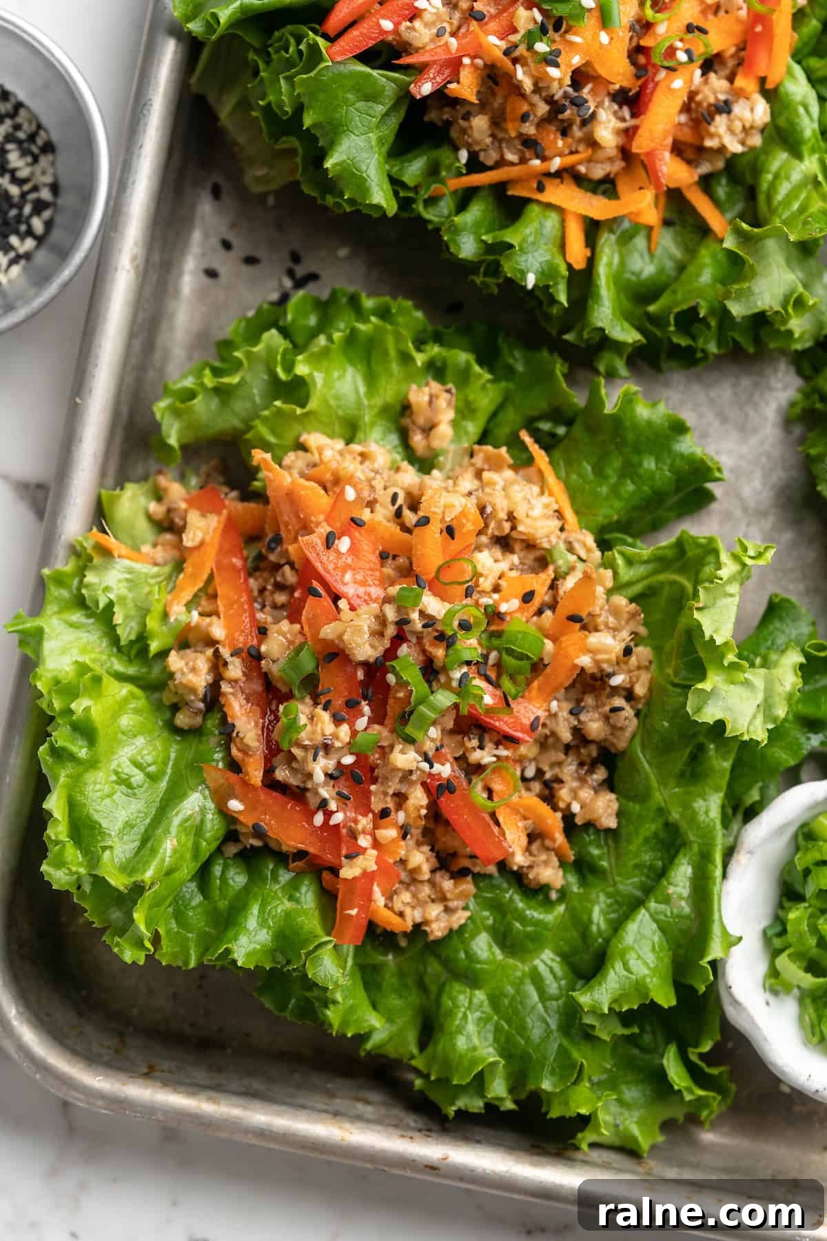 Whether you’re looking for a no-cook dinner or something light and refreshing, you’re going to love these easy Asian-inspired lettuce wraps! Overhead view of lettuce wraps on sheet pan